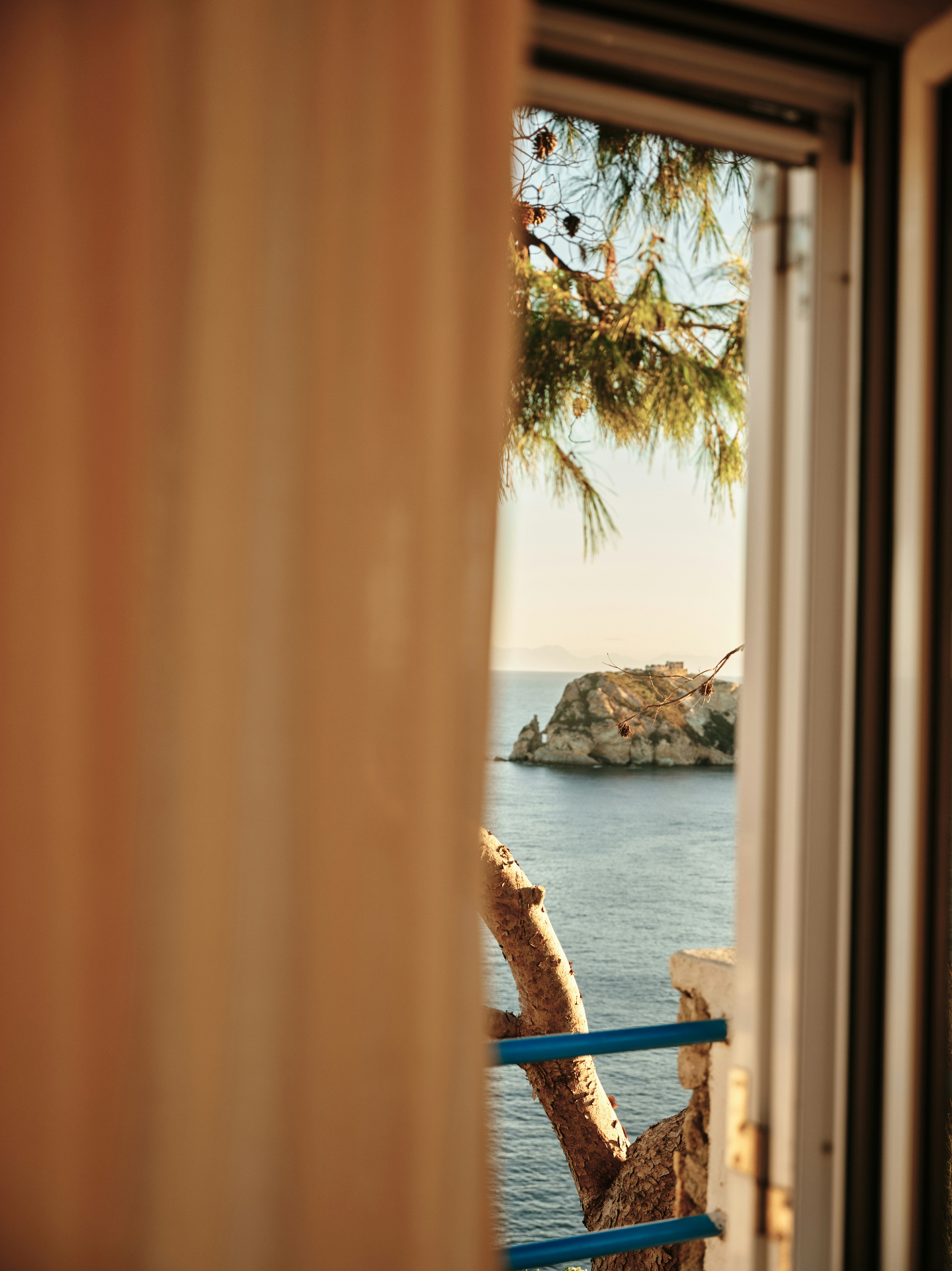 A view of the sea through a wooden window frame
